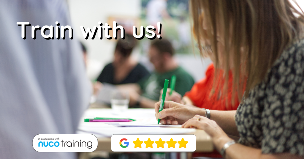 Train with Us! An image of a group of people writing at a Soundcastle training event.